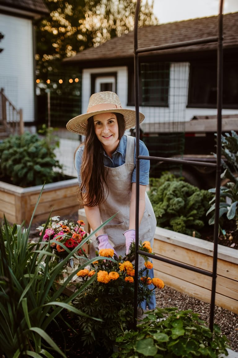 Gardener working at a timber raised bed at a comfortable standing height